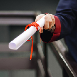 Hand holding out a scroll with a red ribbon tied around it