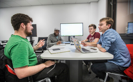 Students doing group work around a table