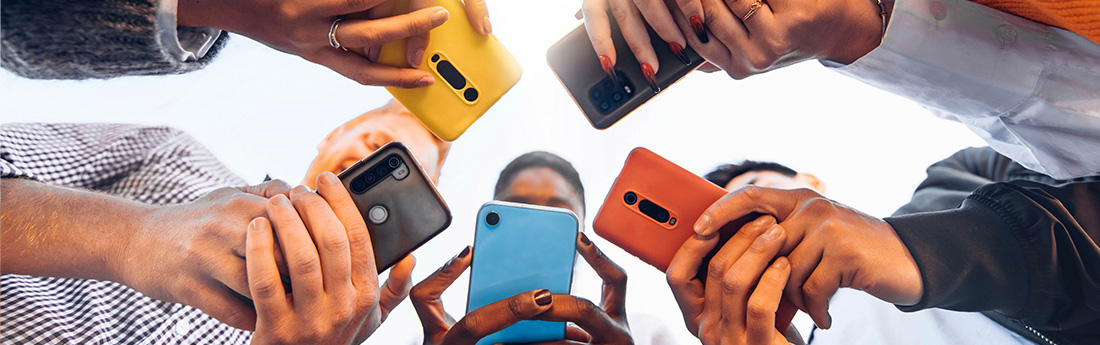 People standing in a circle using smartphones