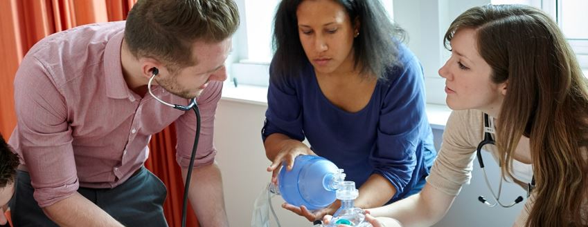 Students working on a dummy