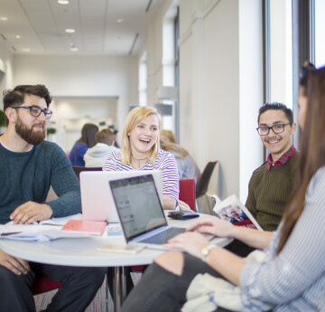 Students having a conversation at a table