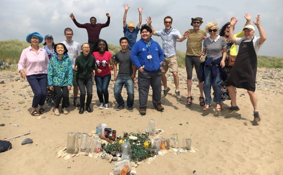 student volunteers on the beach jumping