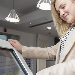 Woman using feedback console in MyUniHub reception